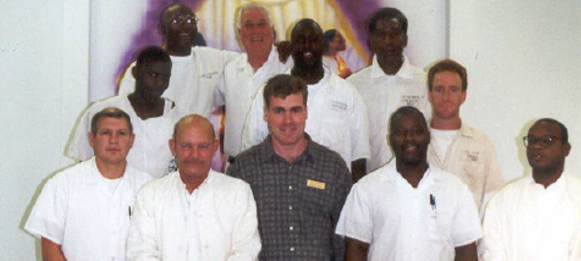 David Landis standing among a group of missionaries